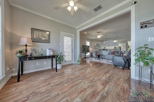 interior space featuring crown molding, light hardwood / wood-style floors, and ceiling fan