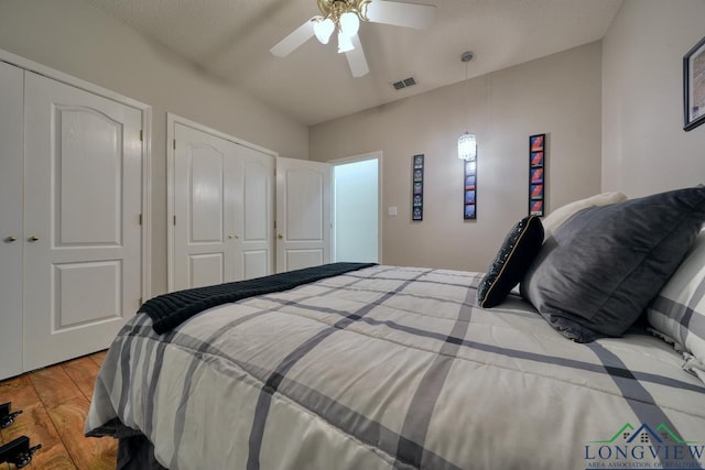 bedroom with a textured ceiling, ceiling fan, and light wood-type flooring