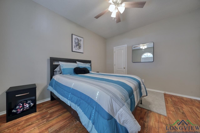 bedroom with dark wood-type flooring and ceiling fan