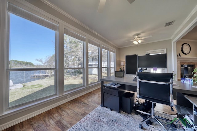 home office featuring hardwood / wood-style flooring, a water view, a wealth of natural light, and ceiling fan