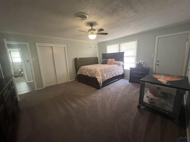 carpeted bedroom with multiple windows, ornamental molding, a closet, and ceiling fan