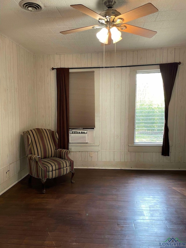 unfurnished room featuring ceiling fan, wooden walls, cooling unit, and dark wood-type flooring