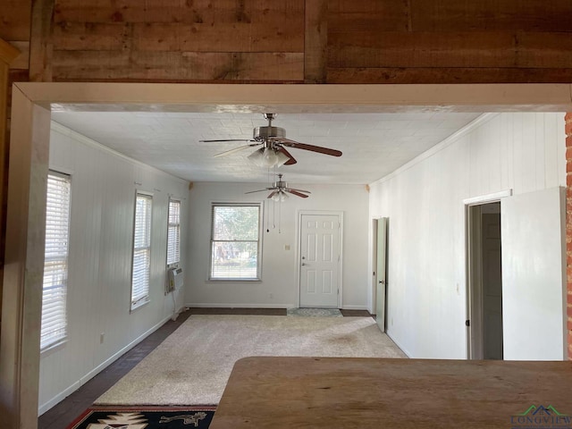 interior space featuring ceiling fan and ornamental molding