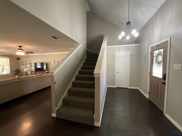 entryway with ceiling fan with notable chandelier and high vaulted ceiling