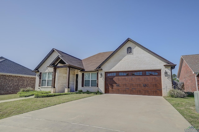 5112 Remington St, Texarkana, TX 75503 - view of front of home featuring brick siding, a garage, a front lawn, concrete driveway, and a shingled roof