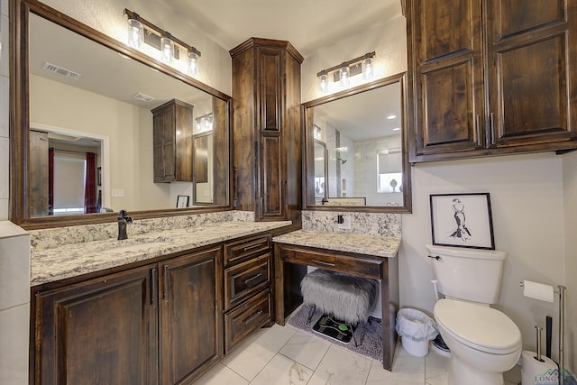 5112 Remington St, Texarkana, TX 75503 - bathroom featuring toilet, vanity, and marble look tiles