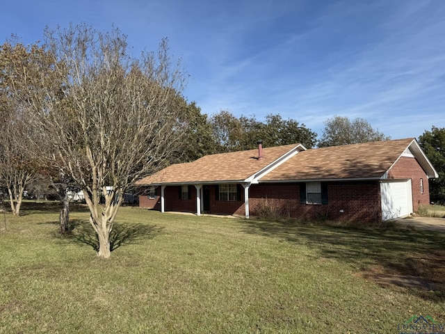 view of front facade with a garage and a front lawn