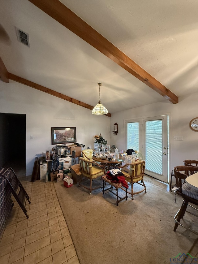 carpeted dining space featuring beam ceiling