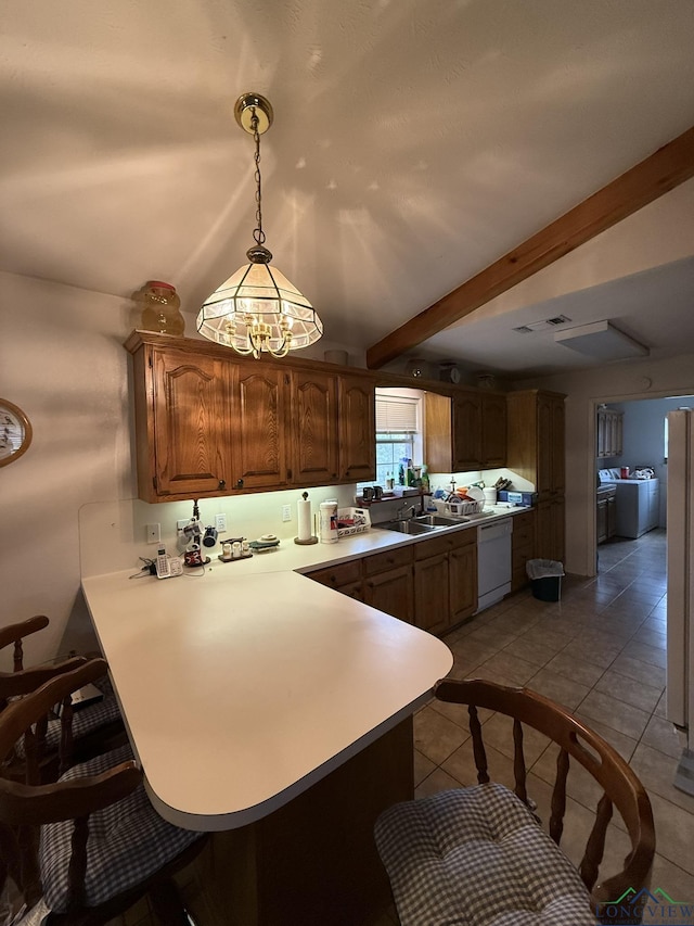 kitchen featuring beam ceiling, dishwasher, hanging light fixtures, kitchen peninsula, and light tile patterned floors