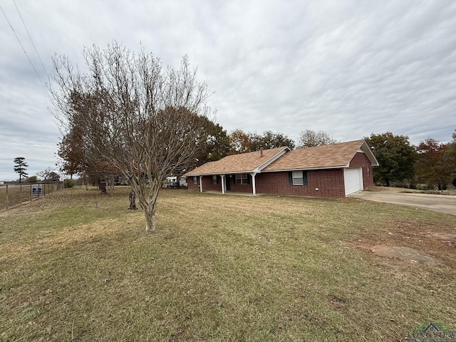 view of front of home featuring a garage and a front lawn