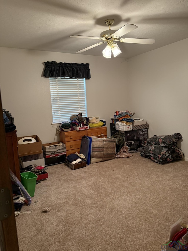 interior space featuring ceiling fan and carpet floors