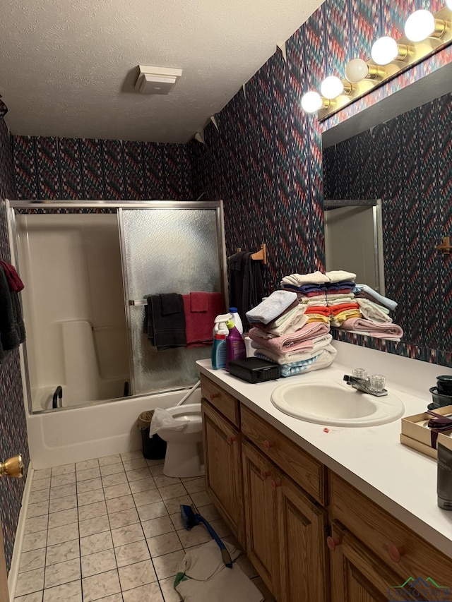 full bathroom with tile patterned floors, vanity, a textured ceiling,  shower combination, and toilet