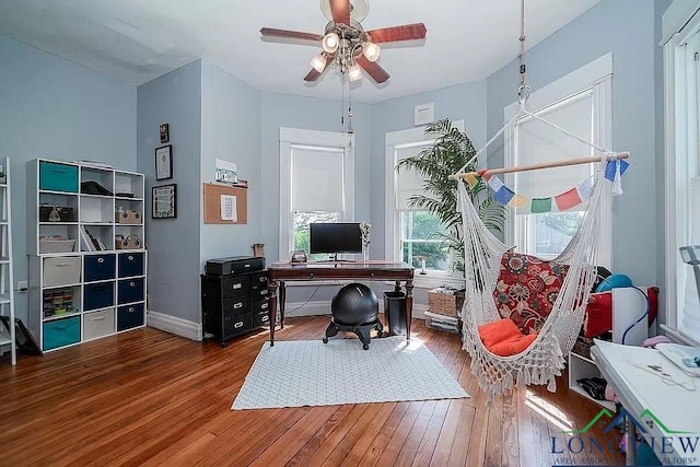 home office featuring hardwood / wood-style flooring and ceiling fan