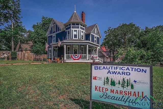 exterior space with a porch and a lawn