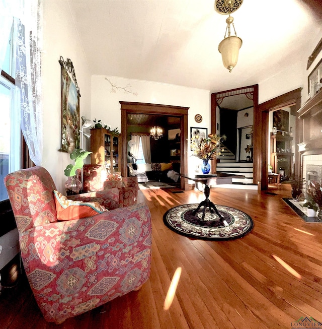 living area with a high end fireplace and wood-type flooring