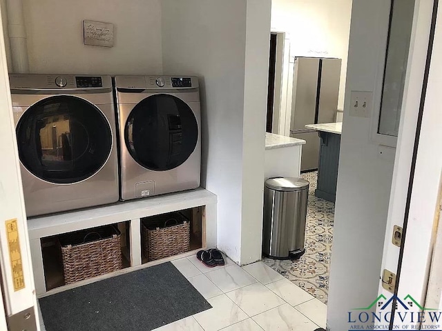 clothes washing area featuring washer and dryer