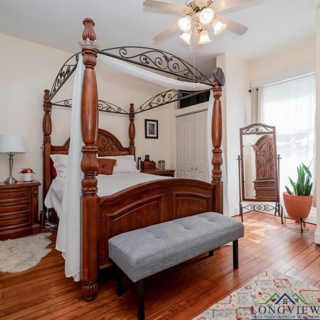 bedroom with hardwood / wood-style floors, ceiling fan, and a closet