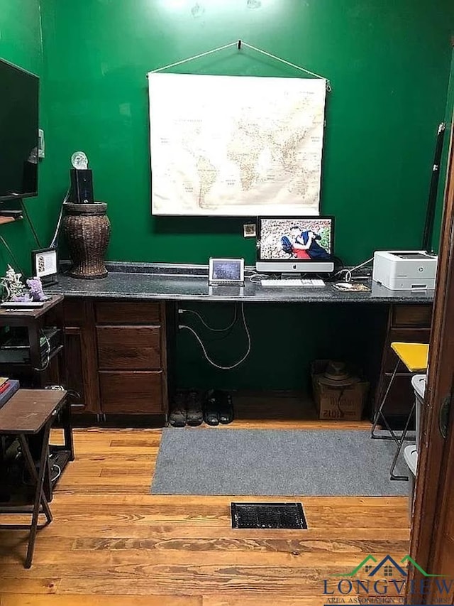 interior space featuring built in desk and light hardwood / wood-style flooring