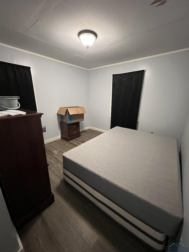 bedroom with dark wood-type flooring