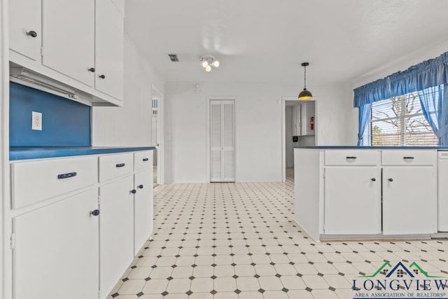 kitchen with white cabinetry, dishwasher, and hanging light fixtures