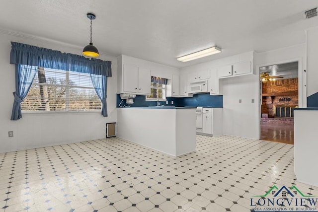 kitchen with ceiling fan, pendant lighting, and white cabinets