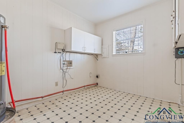 laundry area featuring ornamental molding, wooden walls, and cabinets