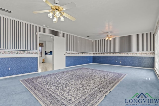 spare room featuring ceiling fan and crown molding