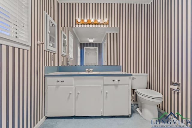 bathroom featuring toilet and vanity