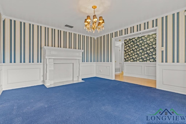 carpeted empty room with a chandelier and crown molding