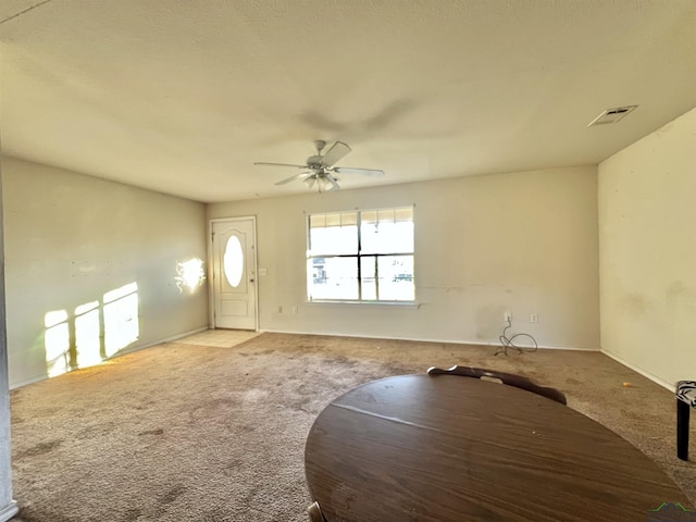 carpeted foyer featuring ceiling fan