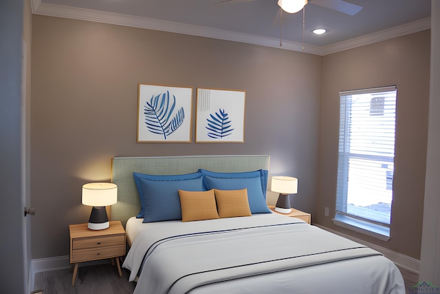 bedroom featuring multiple windows, hardwood / wood-style flooring, ceiling fan, and ornamental molding