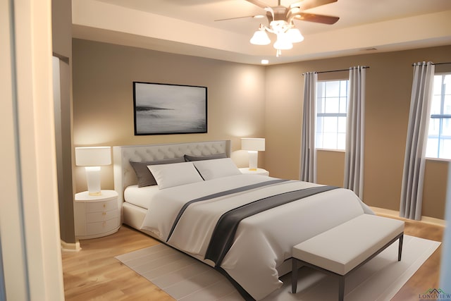 bedroom with multiple windows, ceiling fan, and light hardwood / wood-style flooring