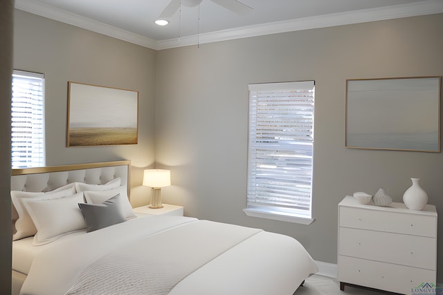 bedroom featuring multiple windows, ceiling fan, and ornamental molding