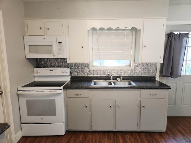 kitchen with white appliances, white cabinetry, dark wood-type flooring, and sink