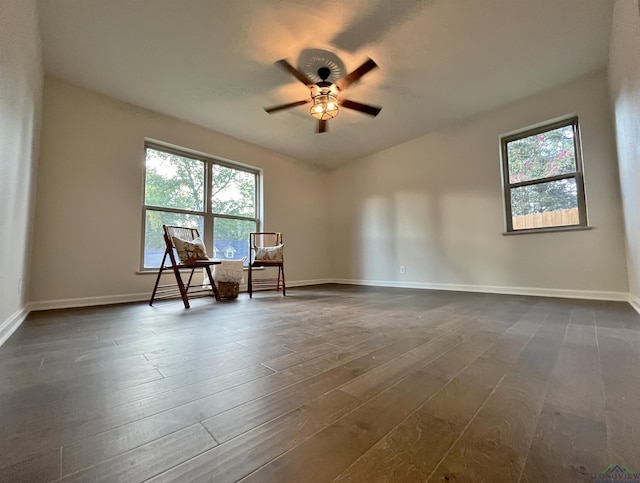 spare room featuring ceiling fan and dark wood-type flooring