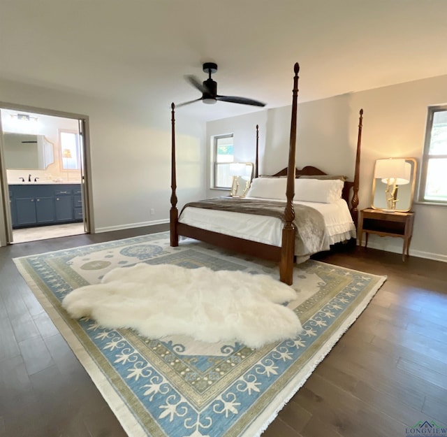 bedroom with connected bathroom, ceiling fan, dark hardwood / wood-style flooring, and sink