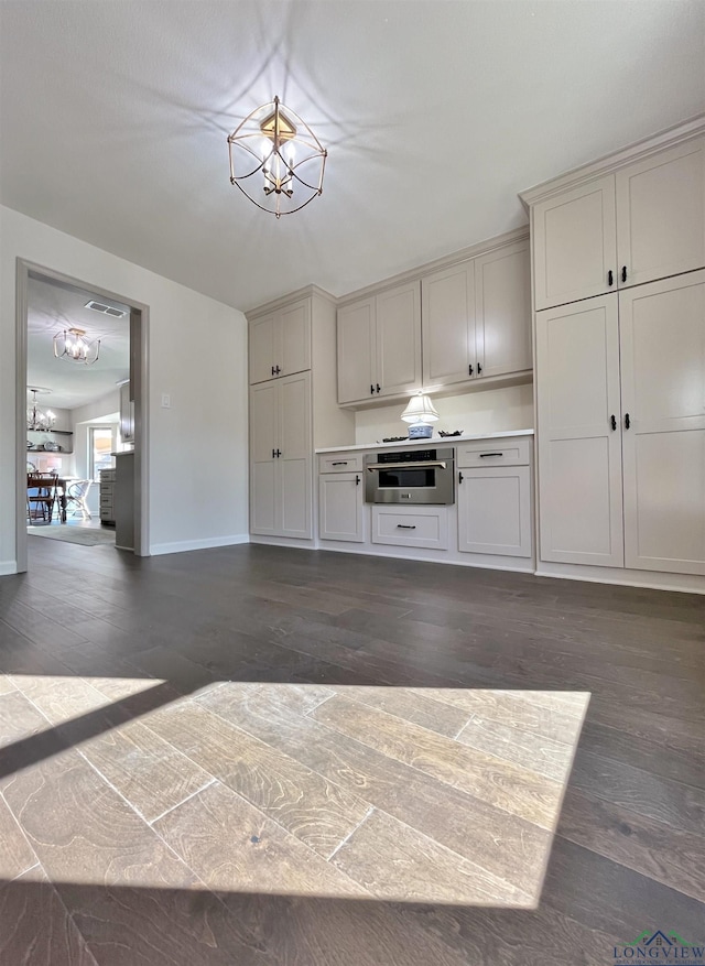 kitchen featuring a chandelier and dark hardwood / wood-style flooring