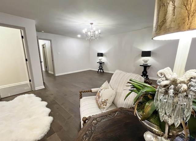 sitting room featuring dark hardwood / wood-style flooring and a chandelier