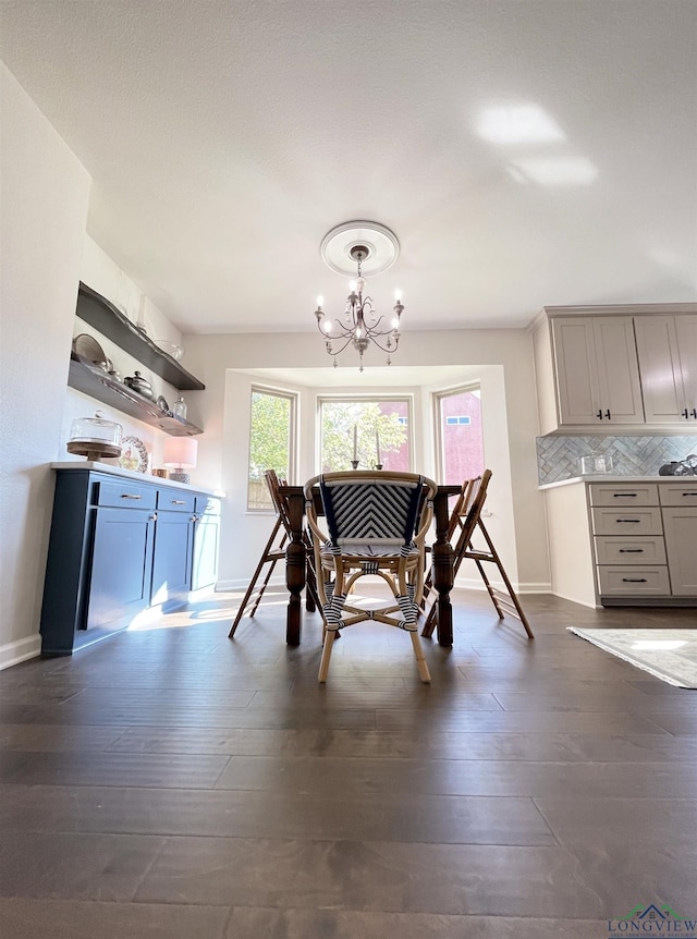 dining area featuring a chandelier and dark hardwood / wood-style floors