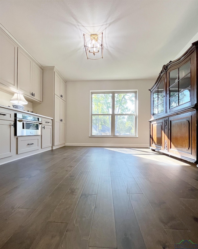 unfurnished living room with dark hardwood / wood-style floors