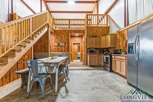 6056 Bobwhite Rd, Gilmer, TX 75645 - kitchen featuring stainless steel appliances, a towering ceiling, and concrete floors