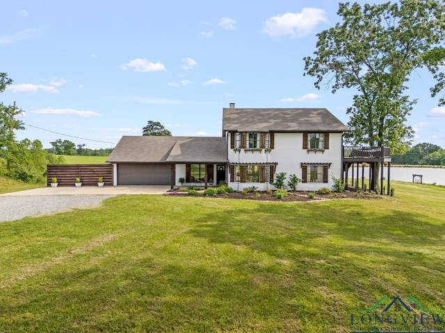 6056 Bobwhite Rd, Gilmer, TX 75645 - view of front facade featuring concrete driveway, a front yard, and an attached garage