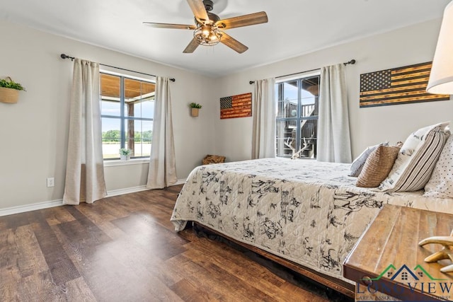 6056 Bobwhite Rd, Gilmer, TX 75645 - bedroom featuring dark wood-type flooring, baseboards, and a ceiling fan
