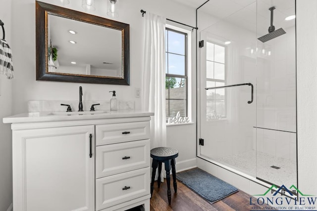 6056 Bobwhite Rd, Gilmer, TX 75645 - full bath featuring a shower stall, vanity, and wood finished floors