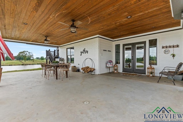 6056 Bobwhite Rd, Gilmer, TX 75645 - view of patio / terrace with french doors, a water view, a ceiling fan, and outdoor dining space
