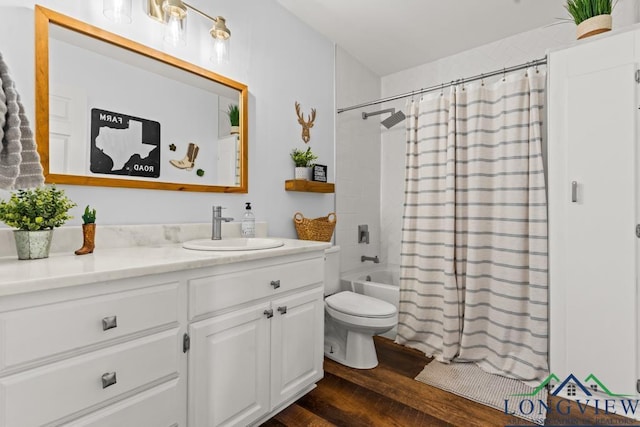 6056 Bobwhite Rd, Gilmer, TX 75645 - full bathroom with wood finished floors, vanity, toilet, and shower / bath combo with shower curtain