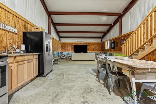 6056 Bobwhite Rd, Gilmer, TX 75645 - kitchen with stainless steel refrigerator with ice dispenser, unfinished concrete floors, a sink, open floor plan, and vaulted ceiling