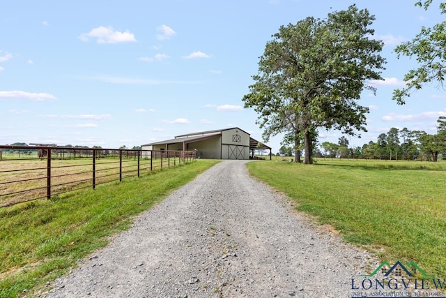 6056 Bobwhite Rd, Gilmer, TX 75645 - view of dirt / gravel driveway with a view of countryside and a pole building