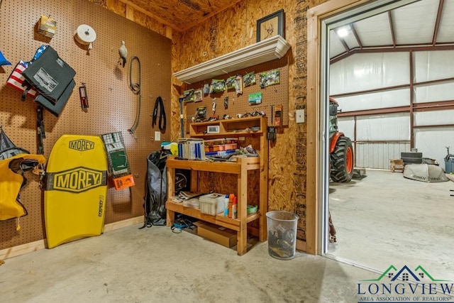 6056 Bobwhite Rd, Gilmer, TX 75645 - misc room with concrete floors, a garage, and a workshop area