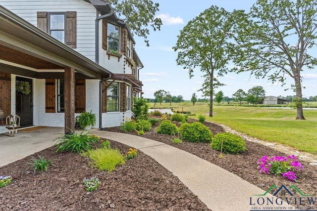 6056 Bobwhite Rd, Gilmer, TX 75645 - view of grassy yard featuring a patio area